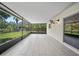 Enclosed lanai featuring tiled flooring, screens, and a view of the backyard at 4639 Cabbage Palm Dr, Valrico, FL 33596