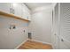 Compact laundry room offering overhead cabinets, connections for laundry, and a white bi-fold closet at 4639 Cabbage Palm Dr, Valrico, FL 33596