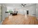 Spacious open floorplan with wood-look floors connecting the living area and modern kitchen at 4639 Cabbage Palm Dr, Valrico, FL 33596