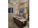 Luxurious bathroom with double sinks, modern fixtures, and elegant lighting at 5017 E 127Th Ave, Temple Terrace, FL 33617