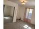 Bright bedroom with plush carpeting, closet with sliding mirror doors and a modern light fixture at 5017 E 127Th Ave, Temple Terrace, FL 33617