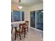 Cozy breakfast nook with glass-top table, chairs, and natural light from large windows at 5017 E 127Th Ave, Temple Terrace, FL 33617