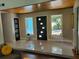 Spacious foyer featuring a modern front door, neutral color palette, and ample natural light at 5017 E 127Th Ave, Temple Terrace, FL 33617