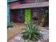 Inviting entrance with a bright green door, contemporary landscaping, and a well-maintained exterior at 5017 E 127Th Ave, Temple Terrace, FL 33617