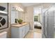 Well-lit bathroom featuring a double vanity, modern fixtures, and a glass-enclosed shower with bright neutral colors at 5719 Silverside Pine Ct, Lakewood Ranch, FL 34211