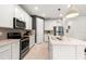 Modern kitchen with stainless steel appliances, light countertops, and sleek cabinetry, blending style and functionality at 5719 Silverside Pine Ct, Lakewood Ranch, FL 34211