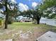 Spacious backyard with mature trees, offering a serene and private outdoor space at 6285 52Nd N Ct, St Petersburg, FL 33709