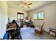 Bright bedroom featuring carpet, two windows, ceiling fan, and packed moving boxes at 6285 52Nd N Ct, St Petersburg, FL 33709