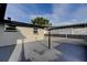A large gray back patio with modern light and privacy fencing at 7031 Magnolia Valley Dr, New Port Richey, FL 34653