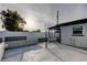 An expansive back patio featuring privacy fences and a modern outdoor light at 7031 Magnolia Valley Dr, New Port Richey, FL 34653
