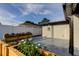 Spacious backyard featuring a patio, flower boxes, and a white fence at 7031 Magnolia Valley Dr, New Port Richey, FL 34653