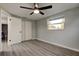 Bedroom has wood flooring, closet with doors, and large window for natural light at 7031 Magnolia Valley Dr, New Port Richey, FL 34653
