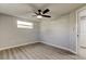 This bedroom features wood floors, neutral paint, one window and a ceiling fan with lighting at 7031 Magnolia Valley Dr, New Port Richey, FL 34653
