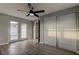 Spacious bedroom features French doors, closet, and ceiling fan, offering a comfortable and stylish retreat at 7031 Magnolia Valley Dr, New Port Richey, FL 34653