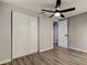 Bedroom showcasing wood floors, ceiling fan and closet at 7031 Magnolia Valley Dr, New Port Richey, FL 34653