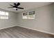 Bright bedroom with ample natural light, featuring gray walls and modern flooring for a serene atmosphere at 7031 Magnolia Valley Dr, New Port Richey, FL 34653