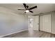 Bedroom features sleek wood floor, ceiling fan, and spacious closets at 7031 Magnolia Valley Dr, New Port Richey, FL 34653