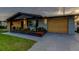 Charming home featuring an attached garage and beautifully landscaped flower bed at 7031 Magnolia Valley Dr, New Port Richey, FL 34653