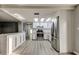 Bright kitchen with skylight, featuring white cabinets, stainless steel appliances, and a breakfast bar at 7031 Magnolia Valley Dr, New Port Richey, FL 34653