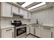 Modern kitchen with stainless steel appliances, white cabinets, and stylish black hardware at 7031 Magnolia Valley Dr, New Port Richey, FL 34653