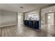 Spacious living room adjacent to a modern kitchen with a breakfast bar and stainless steel appliances at 7031 Magnolia Valley Dr, New Port Richey, FL 34653