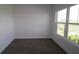 Cozy bedroom with a large window offering a neighborhood view and laminate flooring at 719 Allora Ave, Nokomis, FL 34275