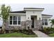 A modern home with a stone facade, and lush landscaping leading to the welcoming front door at 719 Allora Ave, Nokomis, FL 34275