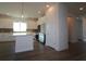 Modern kitchen featuring stainless steel appliances, dark floors, white cabinetry and island at 719 Allora Ave, Nokomis, FL 34275