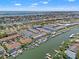 Aerial view of a waterfront community with boats docked along the canal and the open bay in the distance at 751 Pinellas Bayway S # 104, St Petersburg, FL 33715