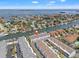 Aerial view of a coastal property on a canal, showcasing the surrounding waterfront community and waterways at 751 Pinellas Bayway S # 104, St Petersburg, FL 33715