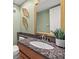 Cozy bathroom with granite counter, contemporary sink, and stylish decor at 751 Pinellas Bayway S # 104, St Petersburg, FL 33715