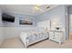 Cozy bedroom with coastal decor, neutral carpet and television at 751 Pinellas Bayway S # 104, St Petersburg, FL 33715