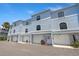 Three-story townhome exterior with garage and a charming door at 751 Pinellas Bayway S # 104, St Petersburg, FL 33715