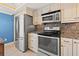 This kitchen features stainless steel appliances and ample cabinet space at 751 Pinellas Bayway S # 104, St Petersburg, FL 33715