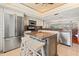 Open kitchen featuring stainless steel appliances, central island with granite countertops, and breakfast bar at 751 Pinellas Bayway S # 104, St Petersburg, FL 33715