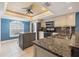 Well-lit kitchen with granite countertops, stainless steel appliances, and stylish island at 751 Pinellas Bayway S # 104, St Petersburg, FL 33715