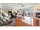 Spacious living room with fireplace, comfortable seating, and access to a balcony at 751 Pinellas Bayway S # 104, St Petersburg, FL 33715
