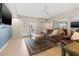 Cozy living room with French doors, a ceiling fan, and comfortable leather seating at 751 Pinellas Bayway S # 104, St Petersburg, FL 33715