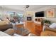 Cozy living room featuring a fireplace and a sliding glass door to balcony at 751 Pinellas Bayway S # 104, St Petersburg, FL 33715