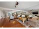 Comfortable living room with fireplace, hardwood floors, and open staircase at 751 Pinellas Bayway S # 104, St Petersburg, FL 33715