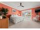 Spacious bedroom with a large bed, ceiling fan, balcony access, and neutral decor at 751 Pinellas Bayway S # 104, St Petersburg, FL 33715