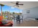 Outdoor patio with views of waterfront, comfortable seating, and stairs to dock at 751 Pinellas Bayway S # 104, St Petersburg, FL 33715