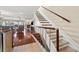 Staircase leading to a living room with a cozy fireplace and bright view at 751 Pinellas Bayway S # 104, St Petersburg, FL 33715