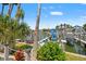 Picturesque waterfront property with boat docks, lush tropical landscaping, and charming waterfront views at 751 Pinellas Bayway S # 104, St Petersburg, FL 33715