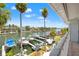Scenic waterfront view from balcony with boats docked, palm trees, and blue skies at 751 Pinellas Bayway S # 104, St Petersburg, FL 33715