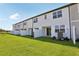View of the townhome backyard featuring a green lawn and privacy fencing at 7683 Deer Valley Circle, Tampa, FL 33635