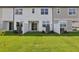 Townhome backyard with green lawn, privacy fence, and sliding glass door at 7683 Deer Valley Circle, Tampa, FL 33635