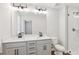Bright bathroom featuring a double sink vanity and tiled shower, perfect for a fresh and modern space at 7683 Deer Valley Circle, Tampa, FL 33635