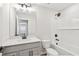 Modern bathroom with sleek fixtures, white subway tile, and a combined tub and shower at 7683 Deer Valley Circle, Tampa, FL 33635