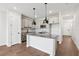 Modern kitchen with stainless steel appliances, gray cabinets, pendant lighting, and center island at 7683 Deer Valley Circle, Tampa, FL 33635